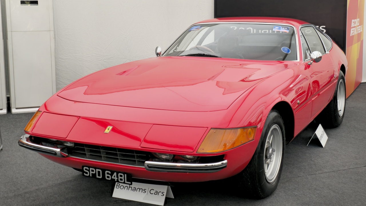 Ferrari Daytona and classic Mercedes roadster parked side by side