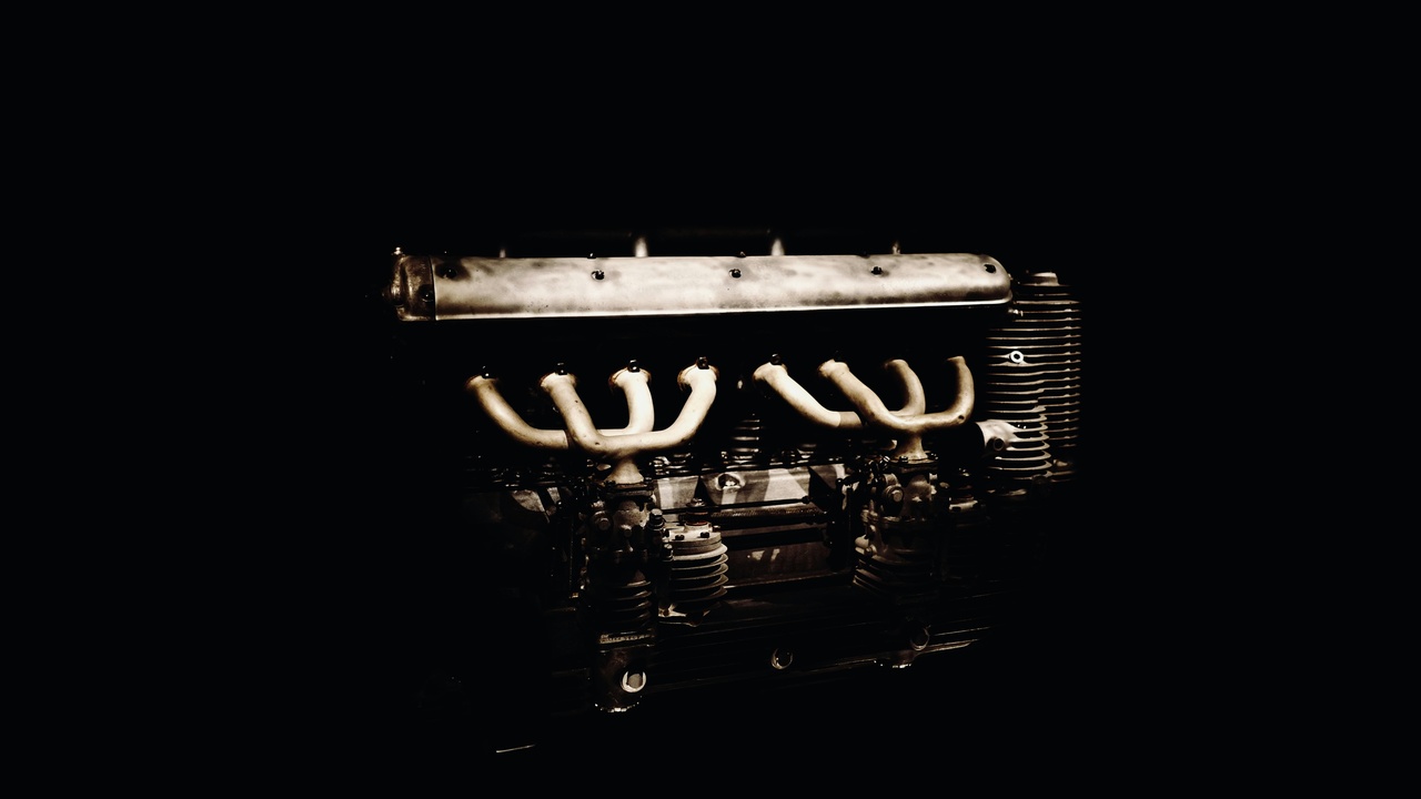 Mechanic inspecting a Lincoln powertrain and electrical components.