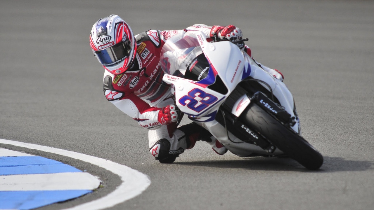Suzuki GSX-R1000 and Kawasaki ZX-10R parked on a racetrack, 2012 models.