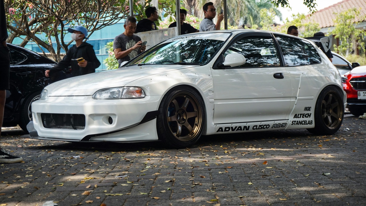 Custom car body kit transformation with wide fenders and splitter