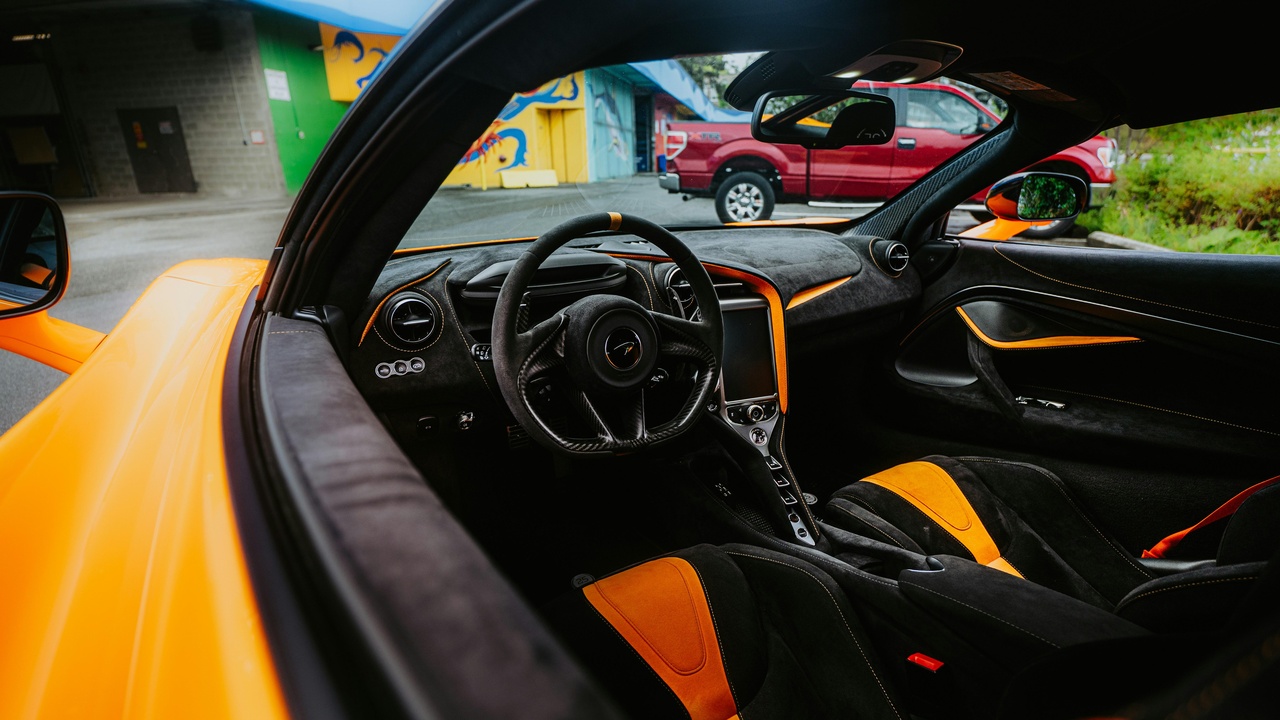 Plush luxury car interior showing leather seats, ambient lighting, and advanced infotainment.