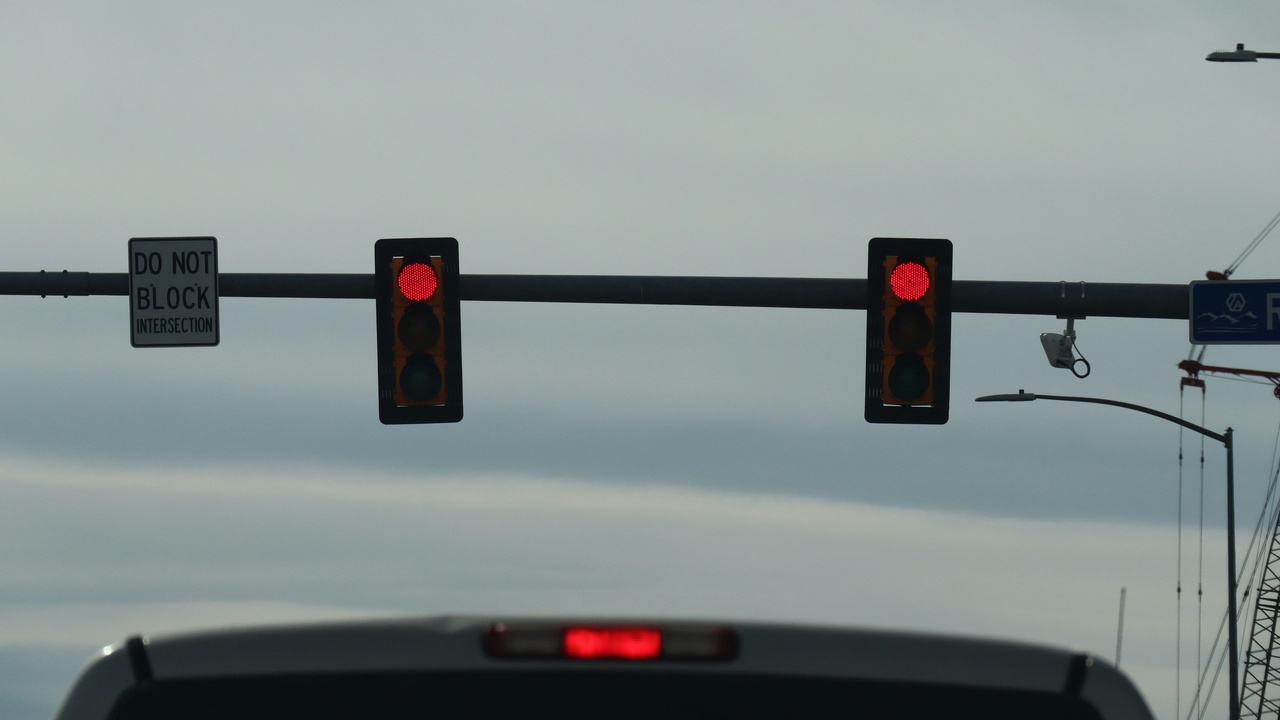Driver dashboard with blind spot indicator and calm driver glancing at side mirror