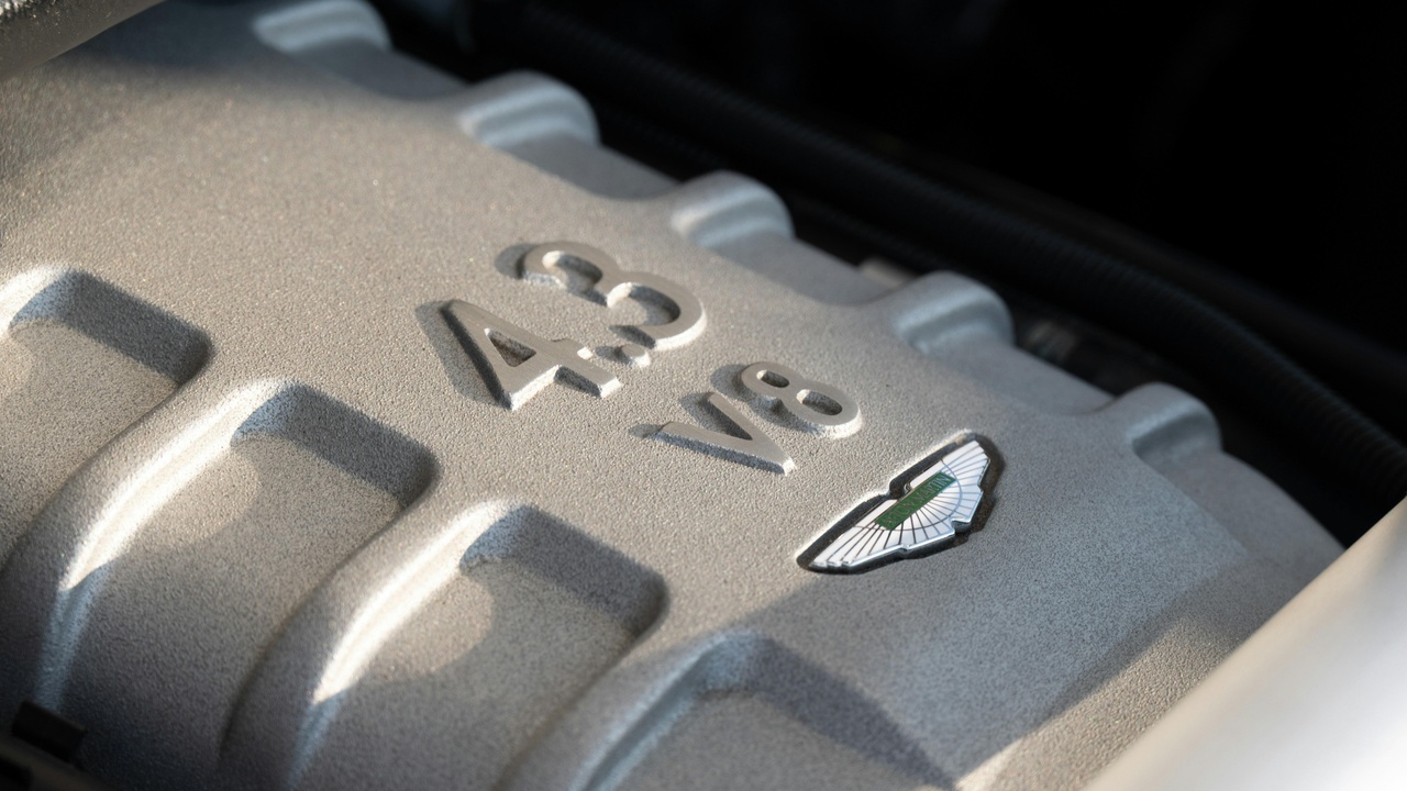 High-end luxury car driving on a winding road, highlighting performance and engineering.