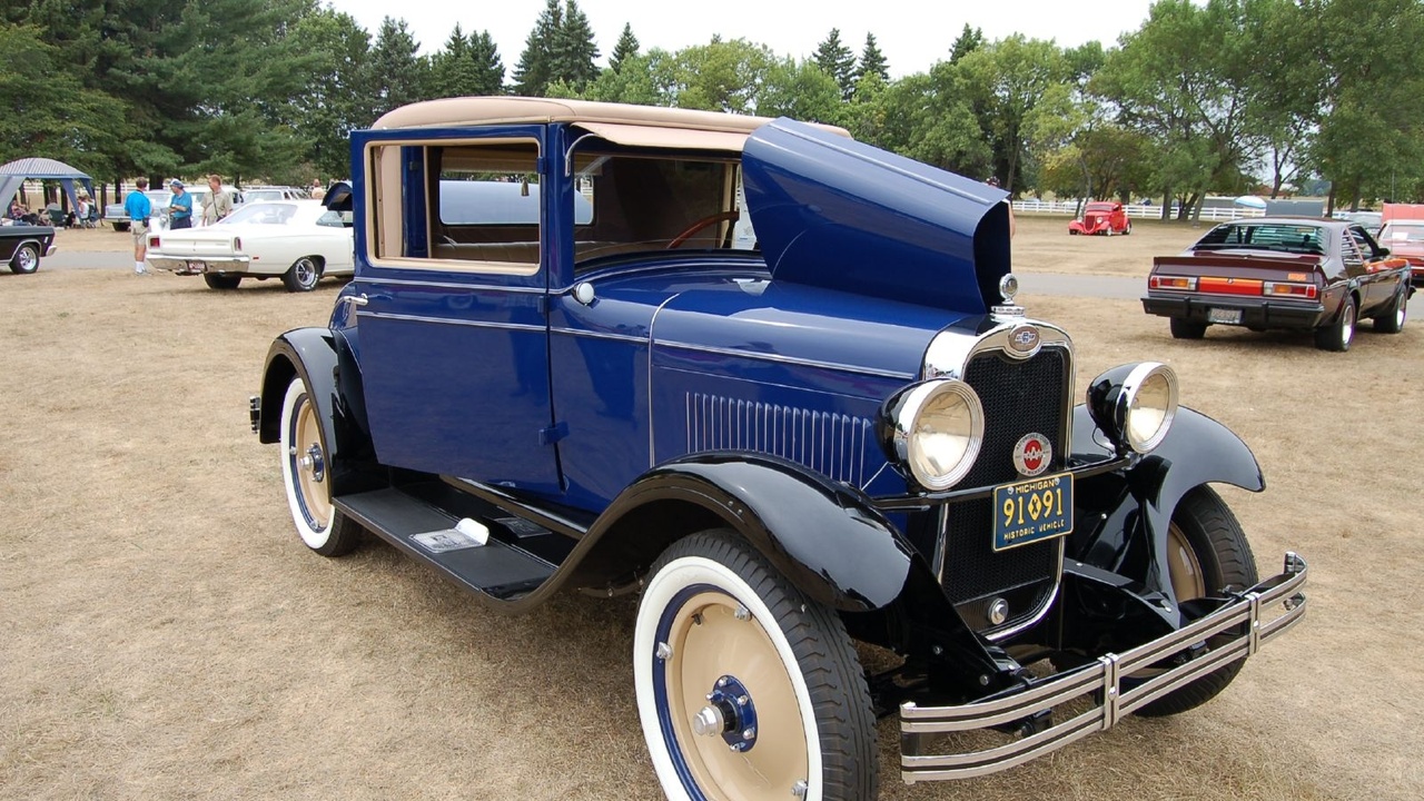 Coupe cornering on a winding road showing aerodynamic profile and low center of gravity.