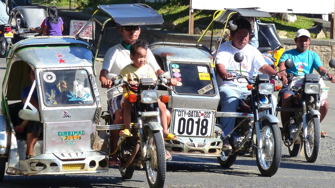 Mechanic performing routine service on a street motorcycle in a garage