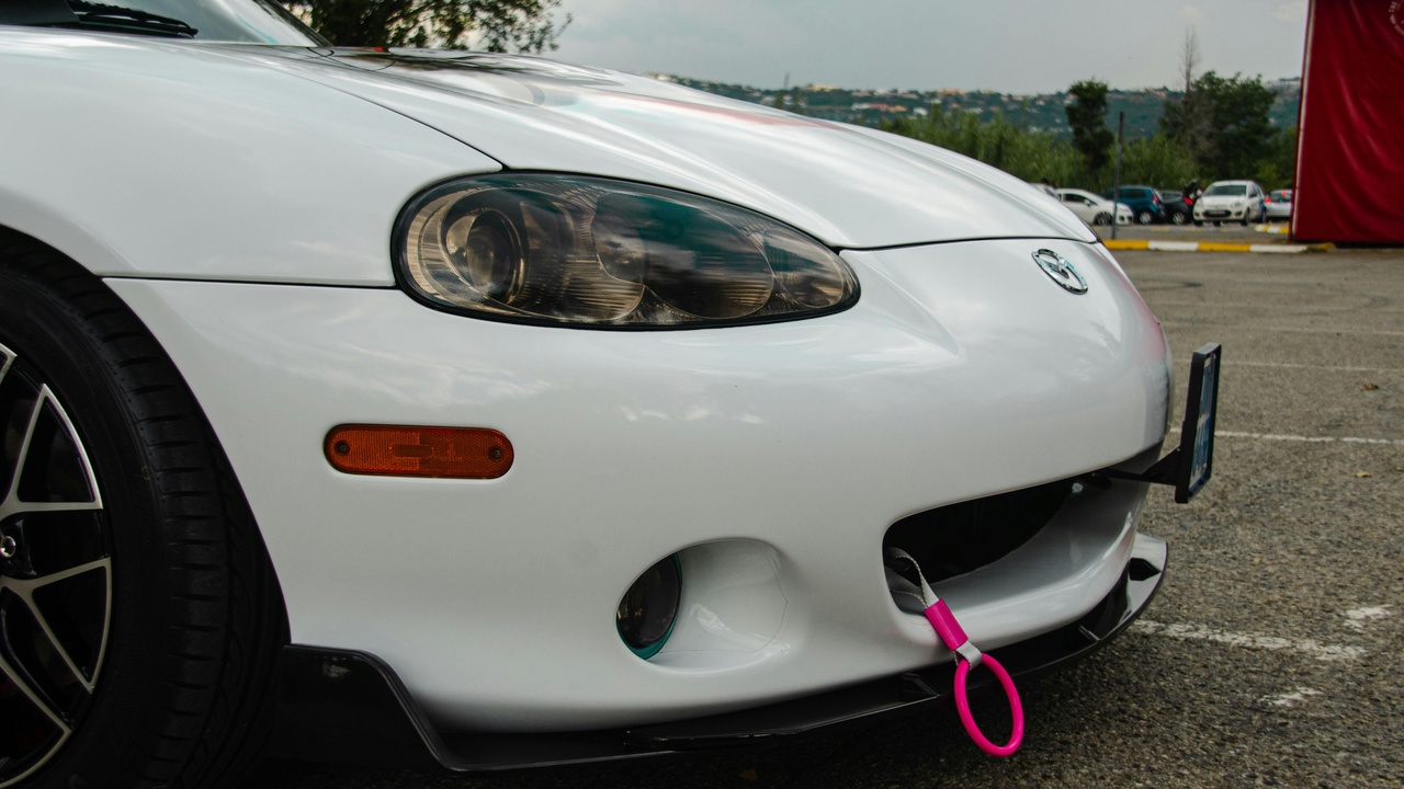 Aftermarket bumper and lip protecting a vehicle from curb scrapes