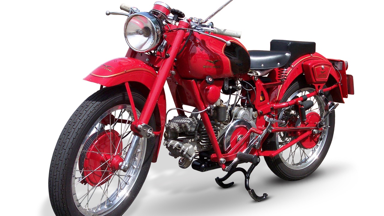 Norton Manx on a race track, representing 1950s racing and durable workhorse motorcycles