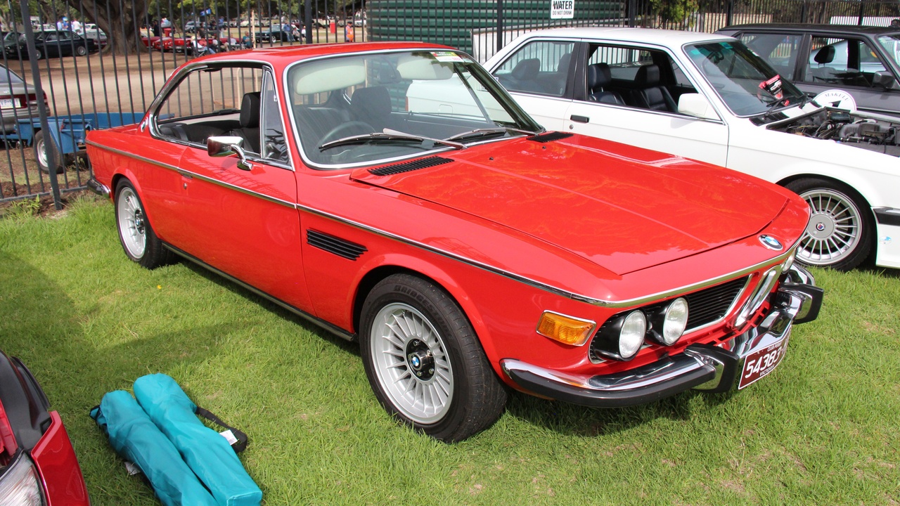 1965 Mercedes 230SL Pagoda and BMW 2000CS parked near a manor