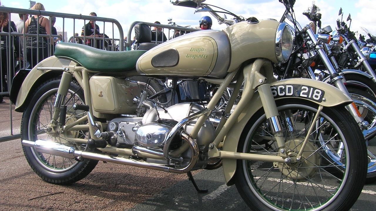 1950s performance motorcycles, showing a Vincent Black Shadow on a coastal road