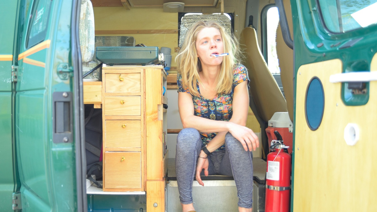 Camper van conversion showing bed and kitchen for weekend travel