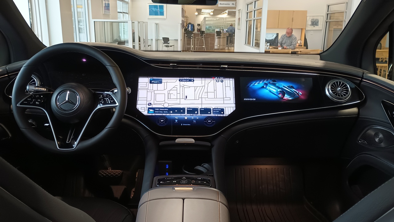 Luxurious SUV interior showing leather seats and large infotainment screen.