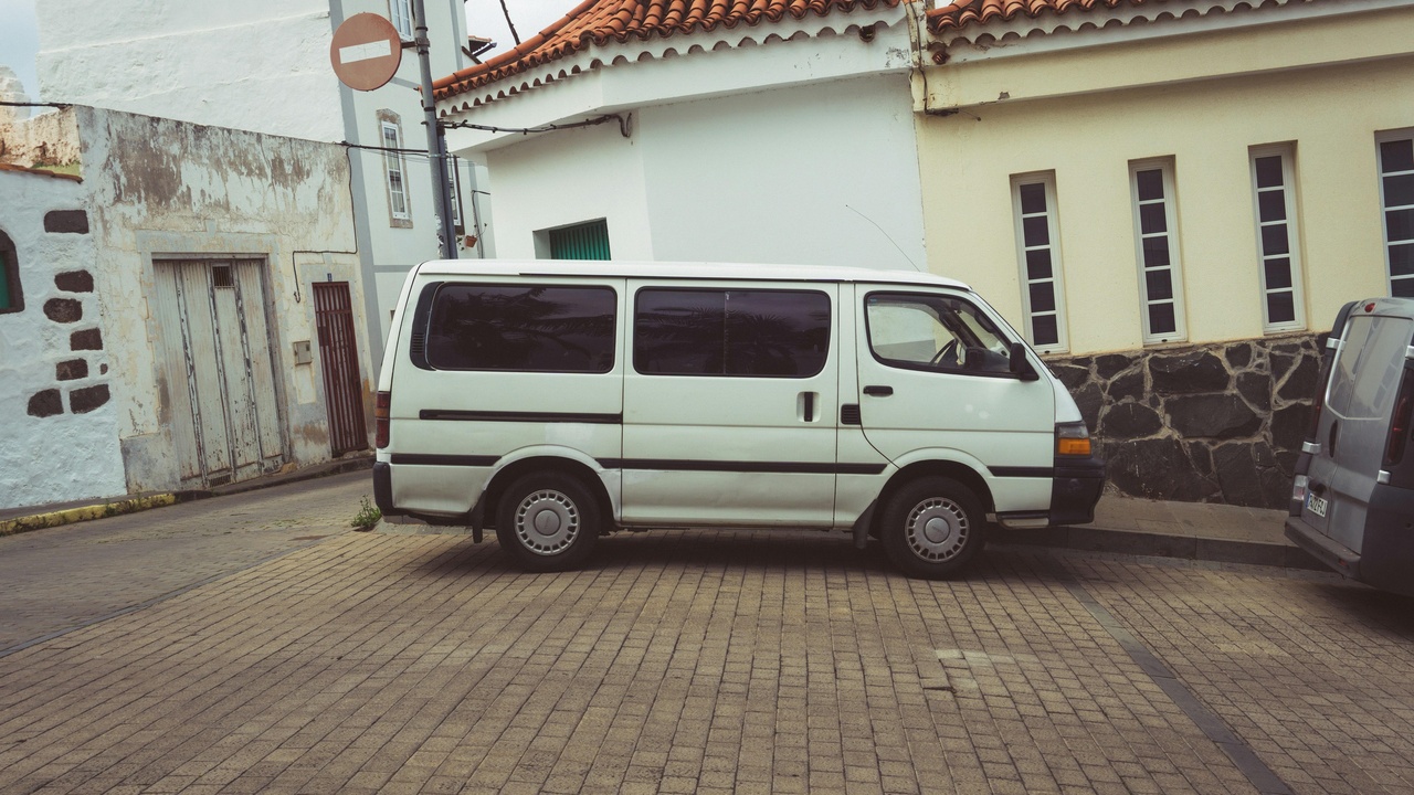 Trade van interior with racks and labeled shelving showing upfits for electricians and plumbers