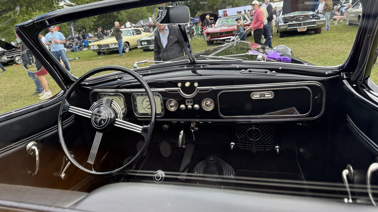 Person cleaning leather car seat with microfiber cloth