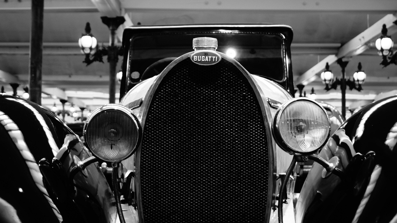 Prewar European coachbuilt car with sweeping fenders and custom bodywork, exemplifying low-volume luxury