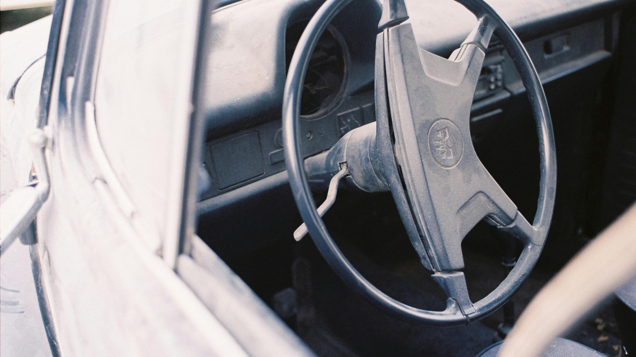 Technician vacuuming car interior and restoring headlight clarity to improve safety and comfort