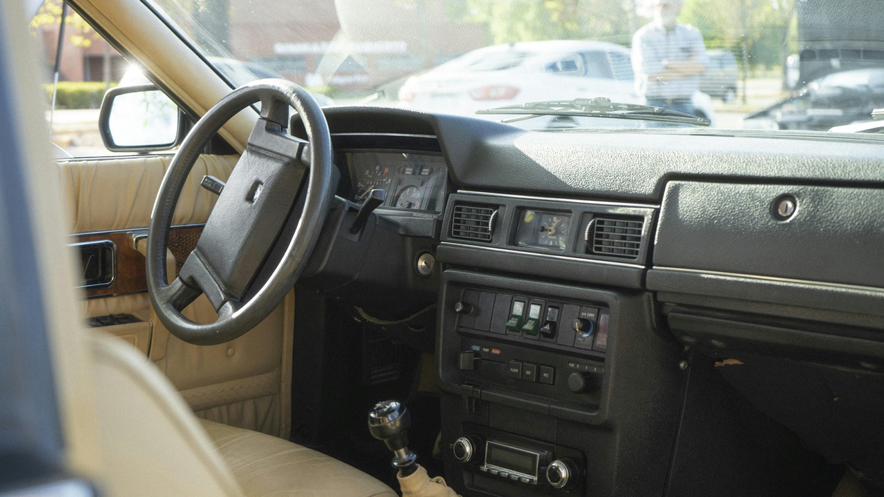 Driver wiping down leather seats with disinfectant cloth