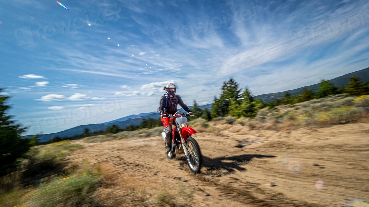 Adventure motorcycle on a dirt trail with skid plate and crash bars visible