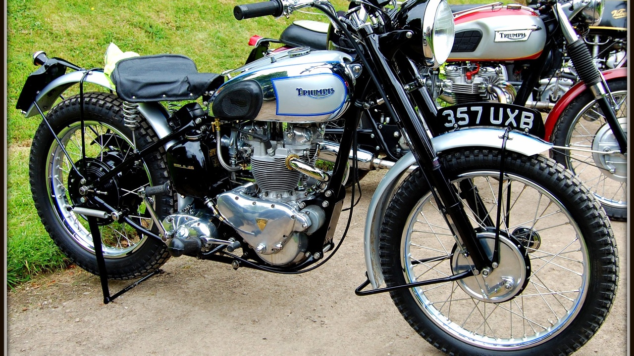 Trail bike navigating technical singletrack with mossy rocks and roots.