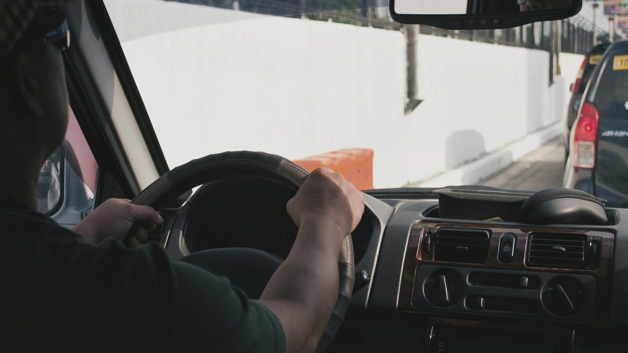 Full-size van on highway showing stability while towing; emphasis on suspension and braking systems