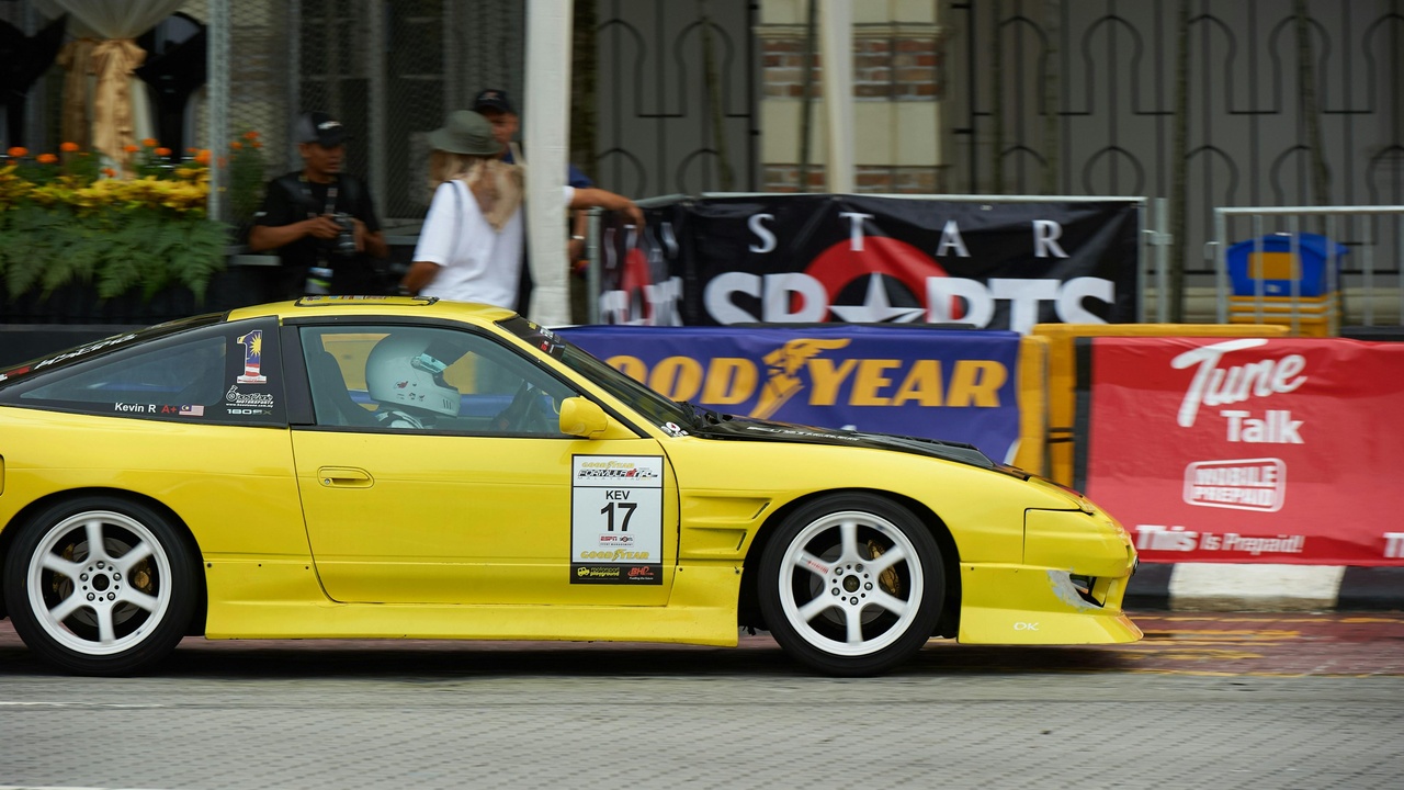 Lightweight sports car on a twisty road representing pure driver's cars of the 2010s