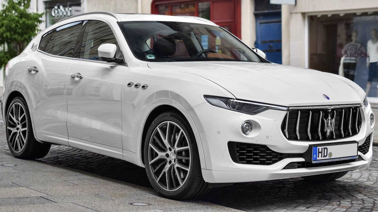 Maserati Levante parked on urban street, showing SUV profile.