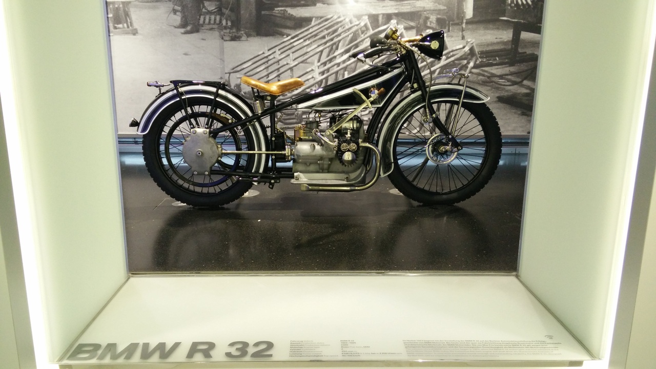 Classic BMW boxer twin motorcycles displayed at a museum