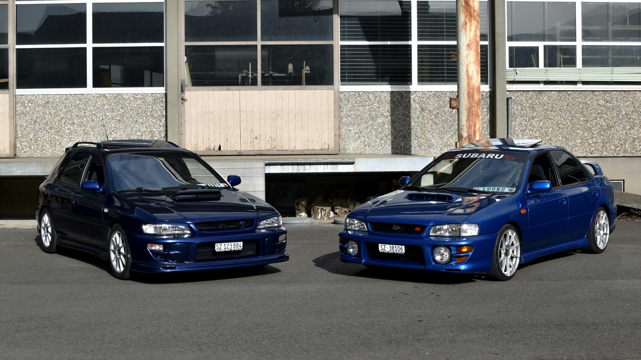 Subaru compact models driving on gravel and parked in the city