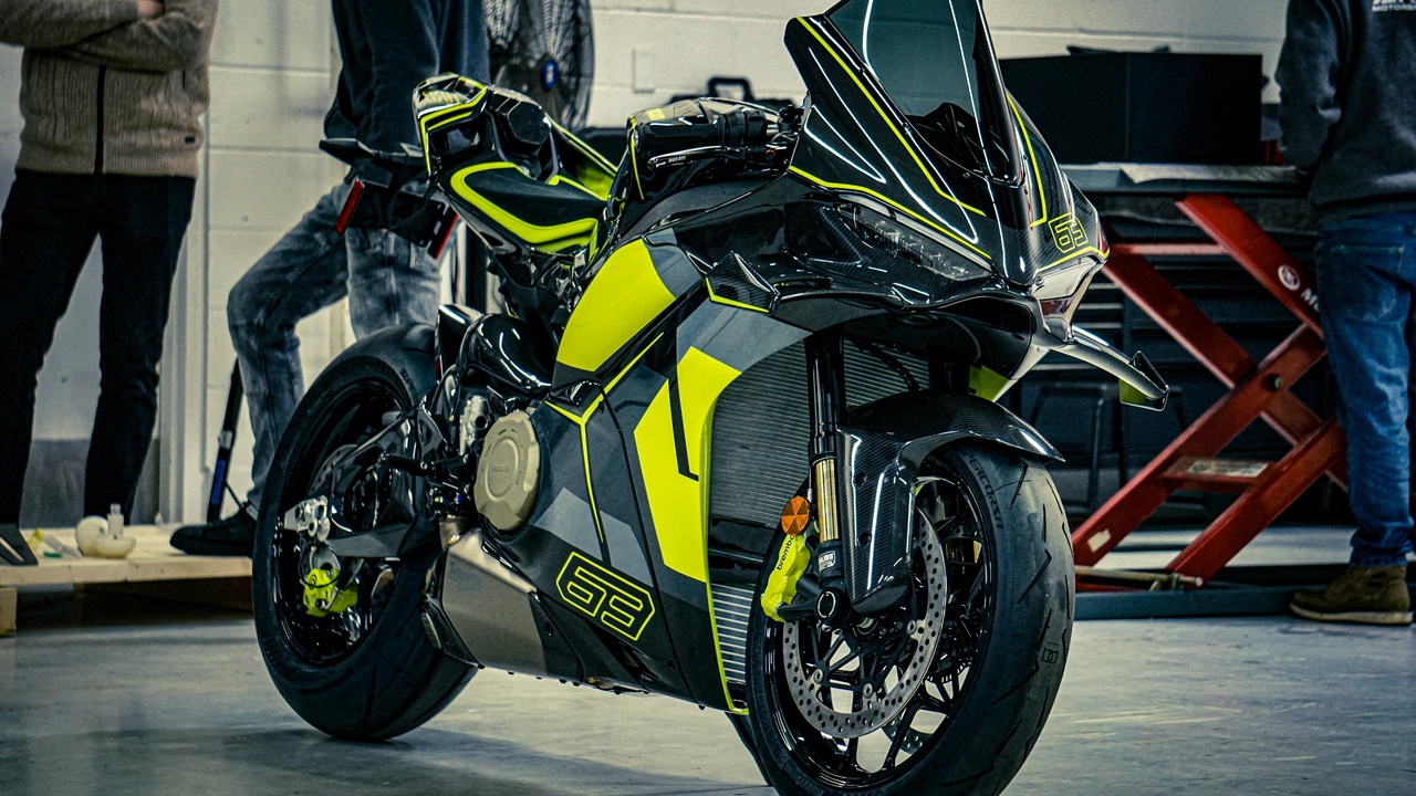 Close-up of a sport bike's aftermarket exhaust and suspension components illustrating upgrade options.