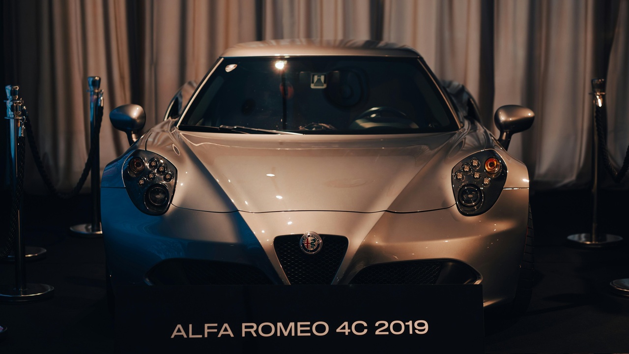 Alfa Romeo dashboard with warning lights and infotainment screen