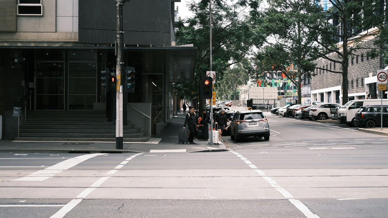 City rider on a Minsk or IZH commuter motorcycle navigating urban streets