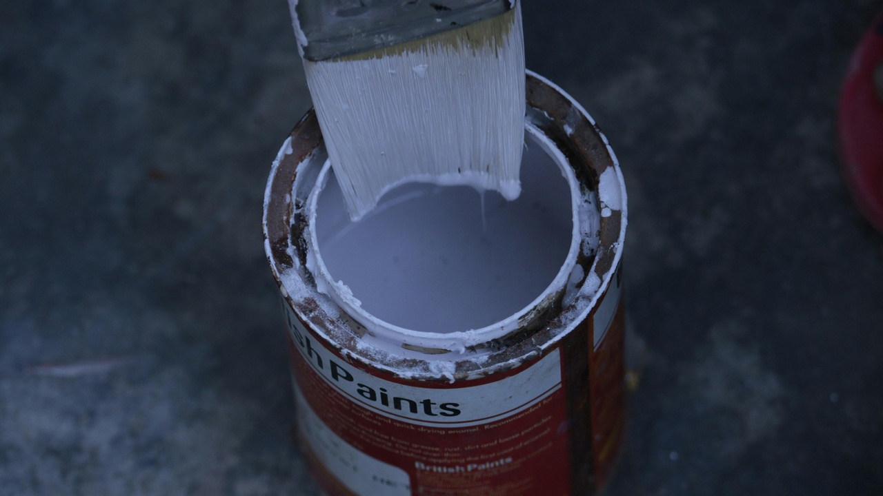 Shiny car hood with water beading showing hydrophobic paint protection film.