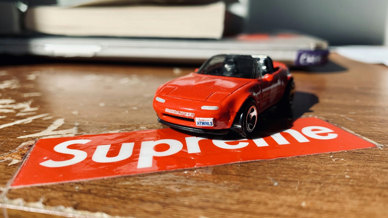 Owner standing beside a limited-production supercar at a brand event