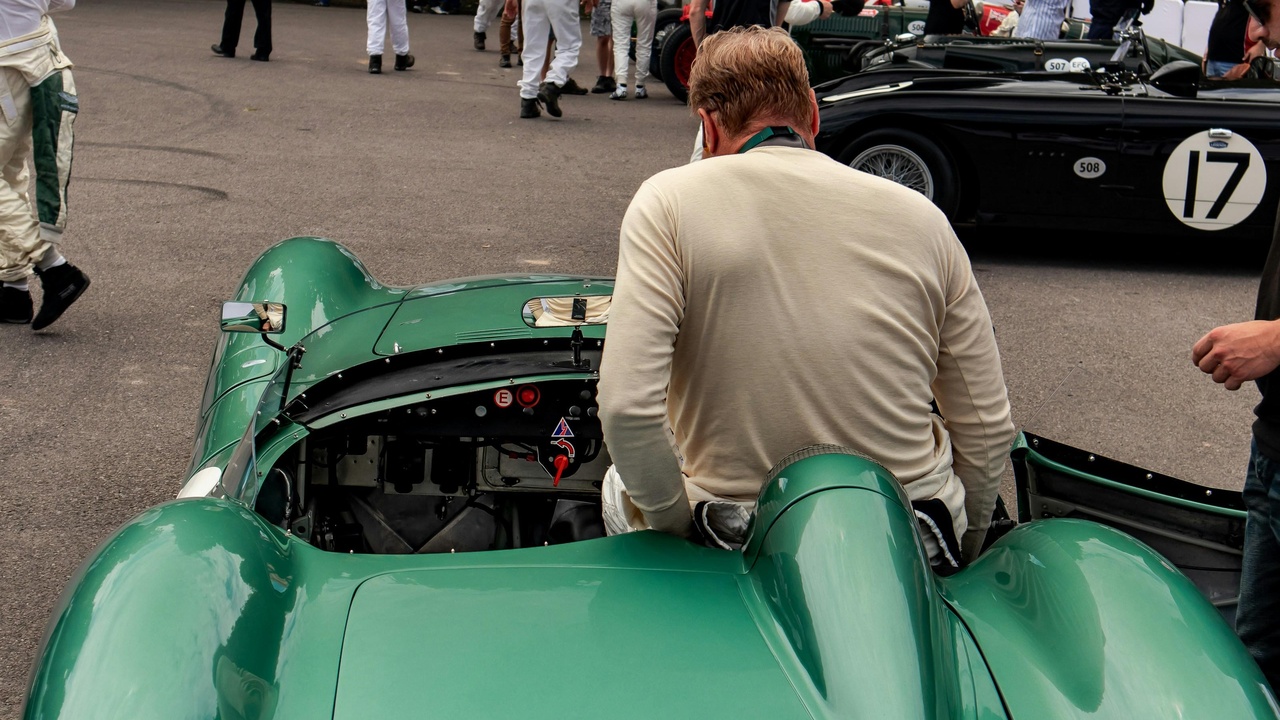 Jaguar D-Type, AC Cobra and Lotus Elan on a racetrack representing British motorsport heritage
