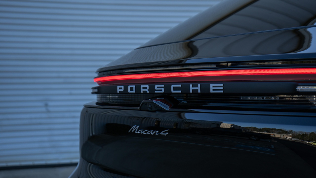 Porsche Macan driving on a highway with luggage