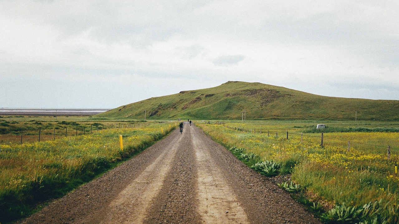A 2021 adventure motorcycle on gravel, loaded with luggage and protective hardware