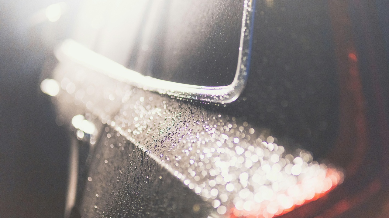 Glossy car finish after ceramic coating showing before and after detailing