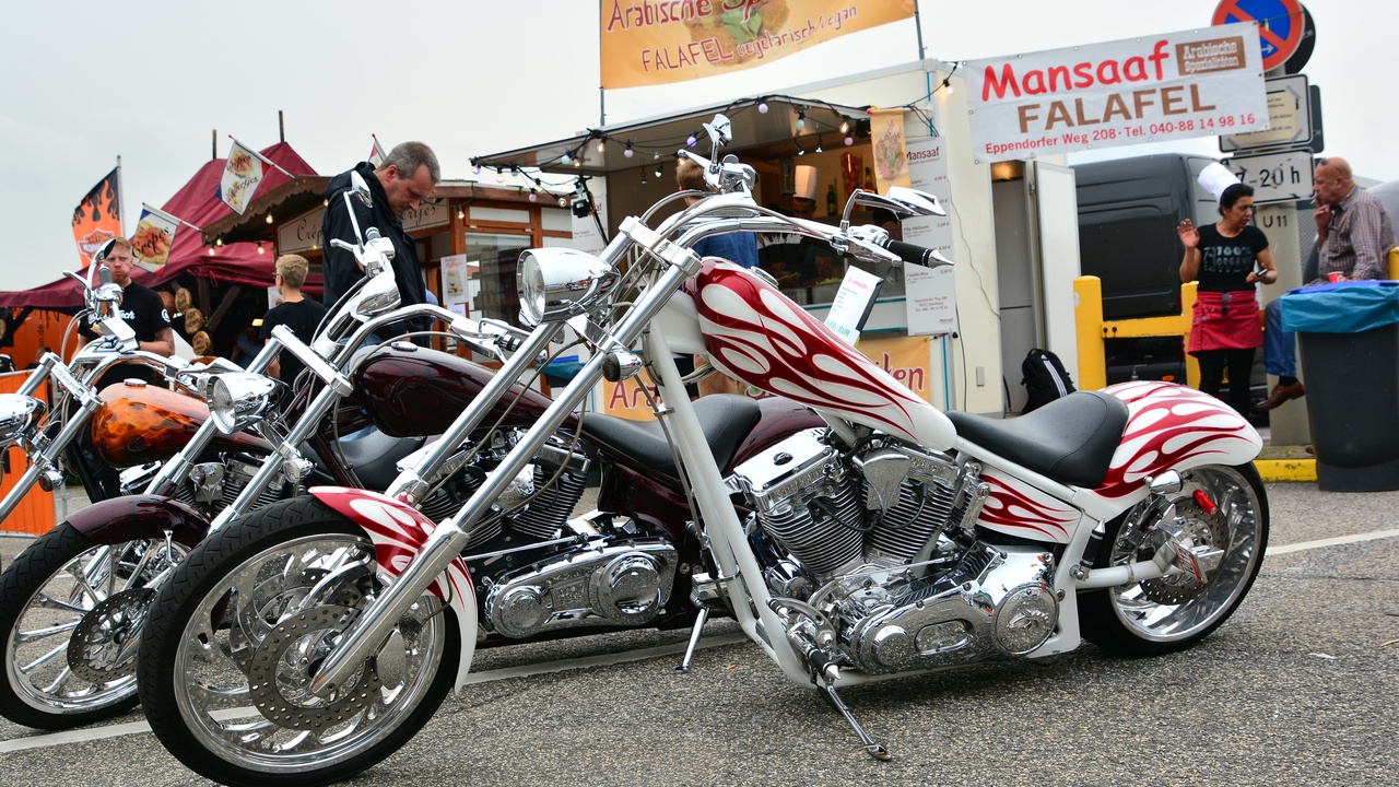 Custom chopper in a garage showing extended forks and unique paint