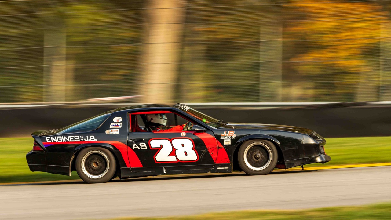 1990 sports car on track showing handling and speed