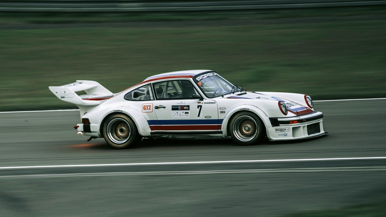 1978 sports car on track with classic car cornering, vintage sports car engine bay