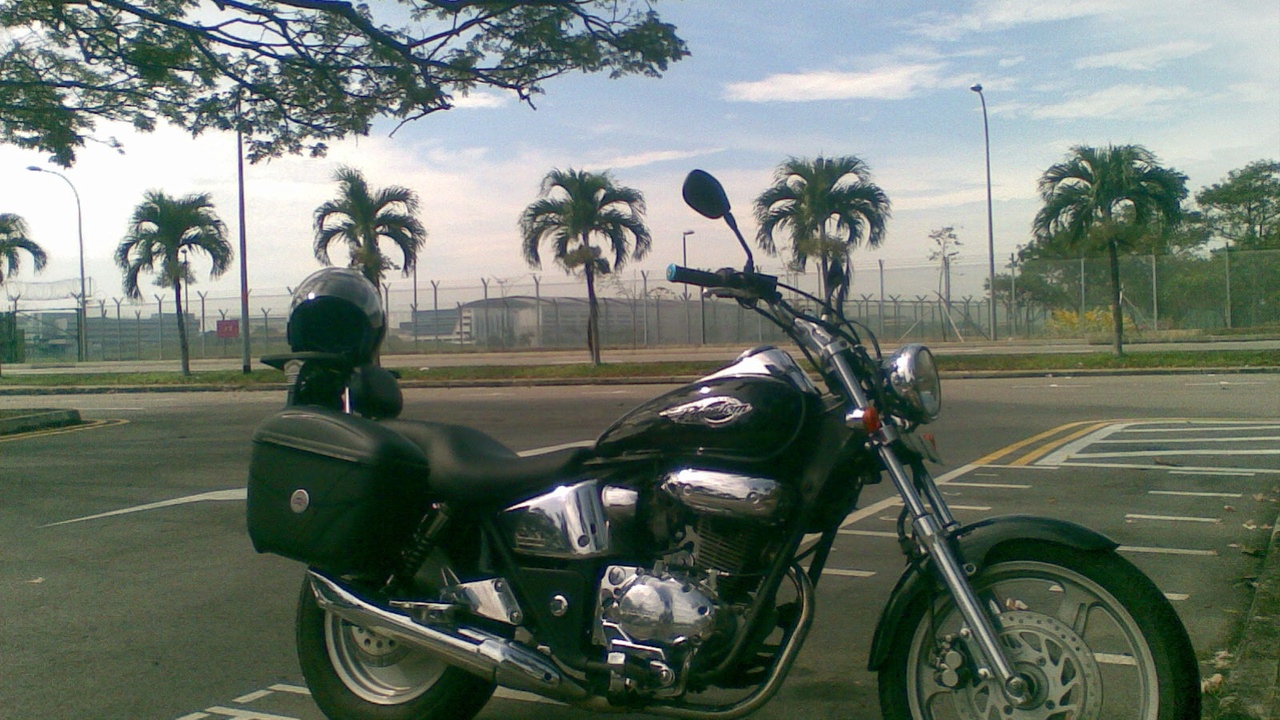 Sport-touring motorcycle with hard panniers on a scenic highway
