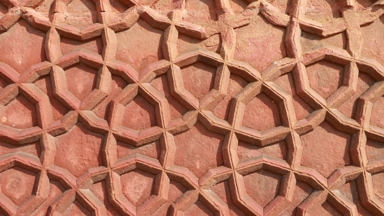 Close-up of ceramic coating on car clear coat showing hydrophobic beading and glossy protection