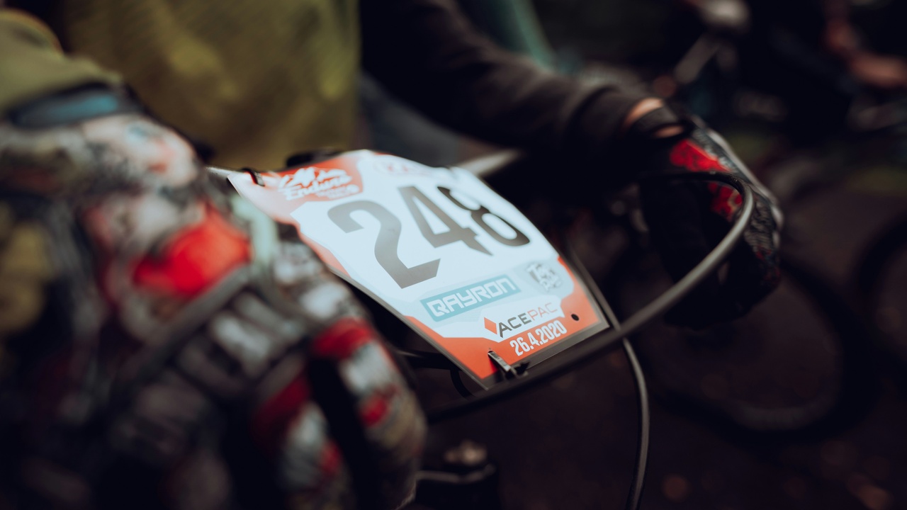 Enduro rider negotiating a technical downhill during a race