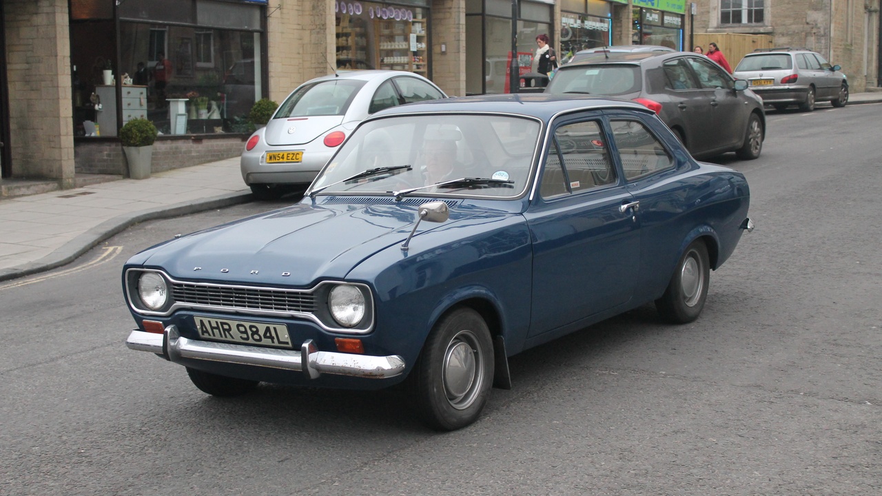 Daily-driven lowered car cruising over imperfect pavement with comfortable suspension