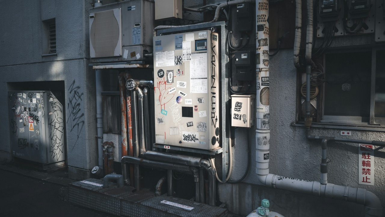 Mechanic servicing a supermoto with community riders nearby