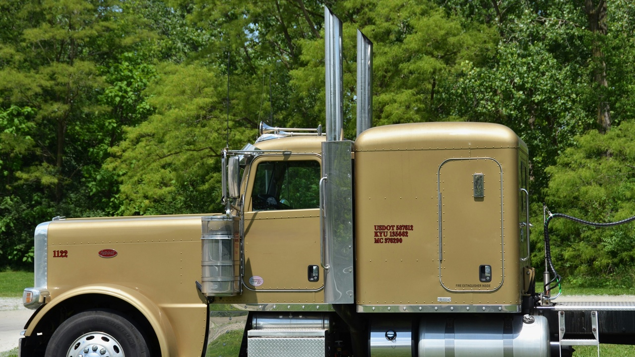Mechanic applying a spray-on bed liner to a pickup truck
