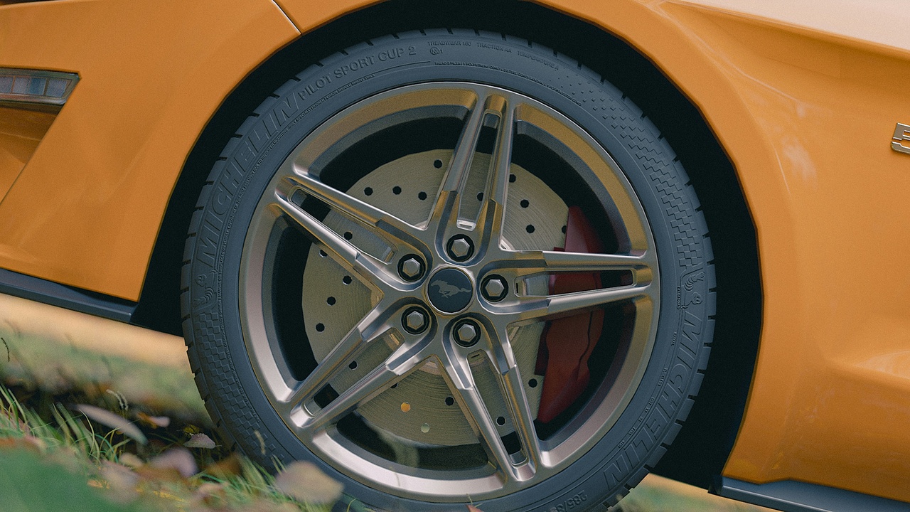 Mechanic mounting tires on aftermarket rims with pricing tags, illustrating cost and resale advantages of wheel upgrades