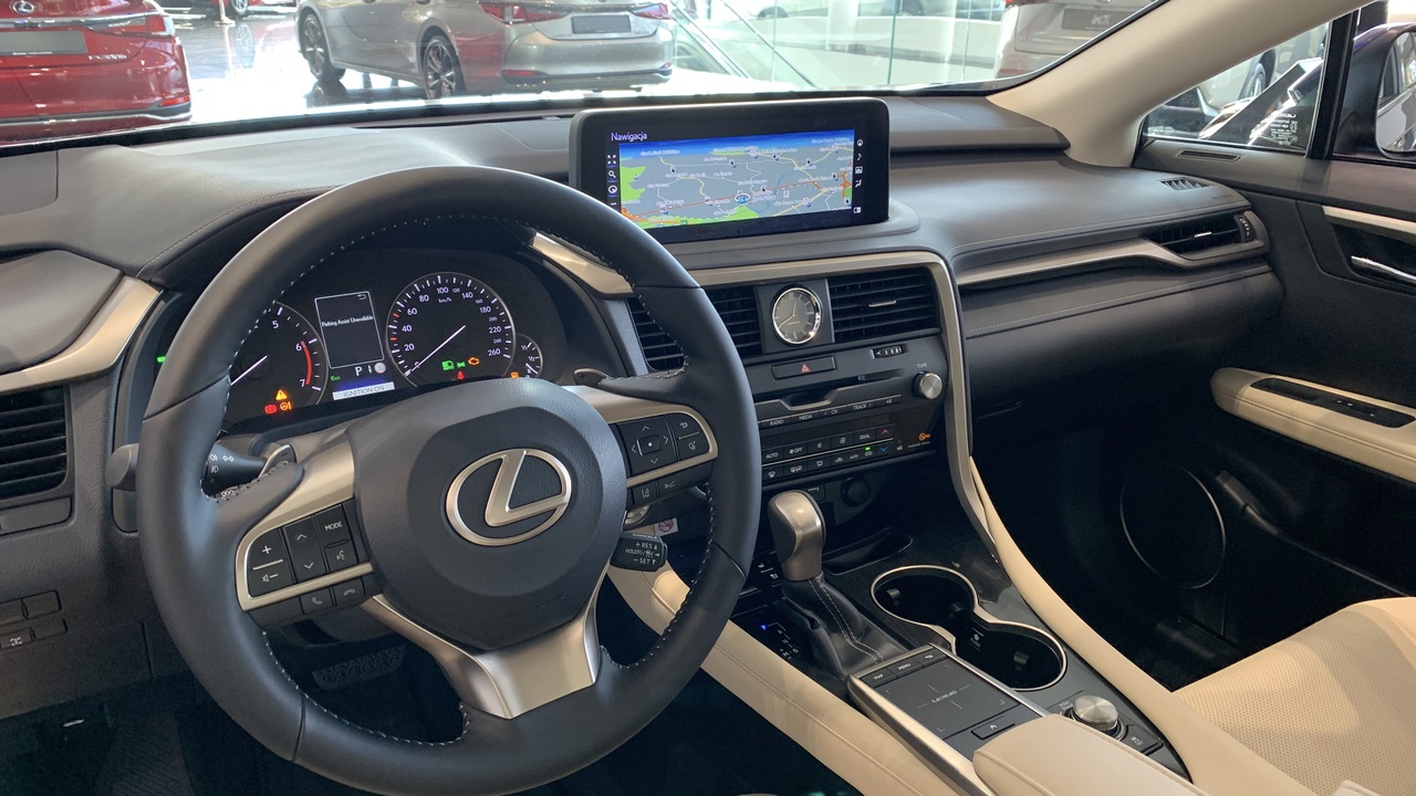 1997 luxury sedans parked at a hotel: BMW 7 Series, Lexus LS400