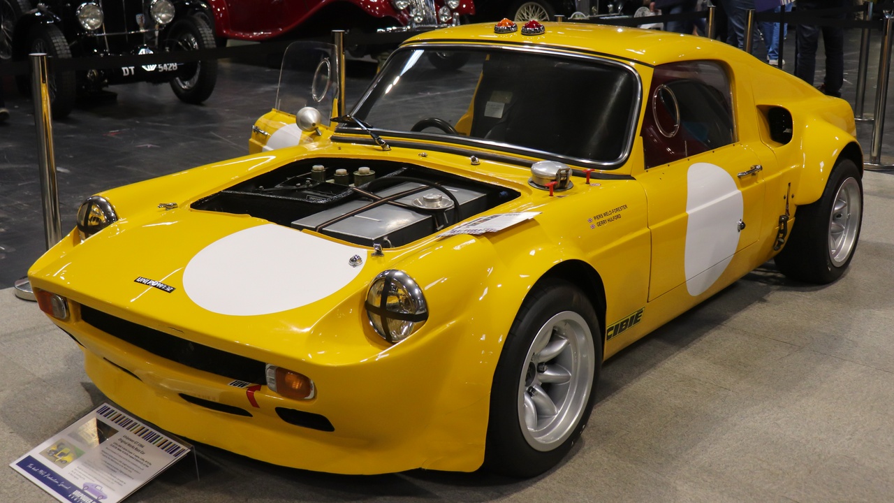 1960s race cars including Shelby Cobra and Lamborghini Miura engine bay