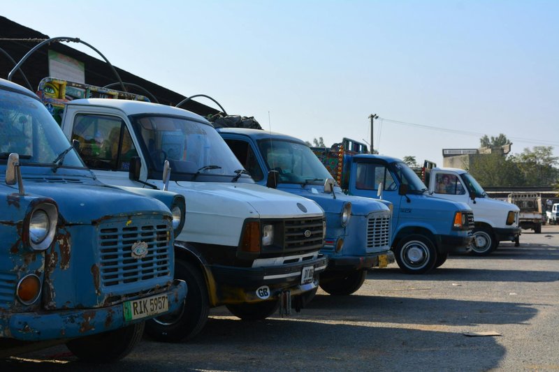 A collection of classic Ford vans parked in Taxila, showcasing vintage automotive design.