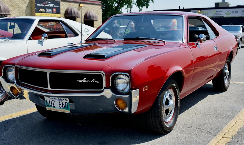 Classic red AMC Javelin displayed at a car show in Winnipeg, Manitoba, Canada.